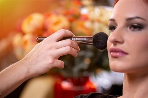 Premium Photo | Makeup artist applying liquid tonal foundation on the ...