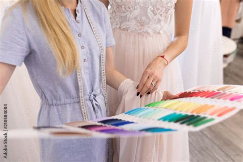 Fitting a wedding dress in the office of a seamstress and choose the ...