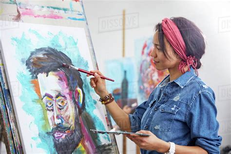 Female artist painting in art studio - Royalty-free Stock Photo | Dissolve