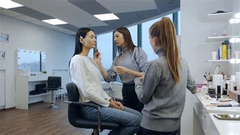 Makeup Lesson. Student Make-up Artist Applies Makeup To a Girl Model in ...