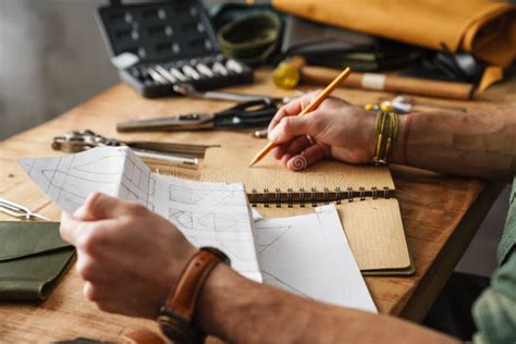 White Craftsman Drawing while Working with Leather Stock Photo - Image ...
