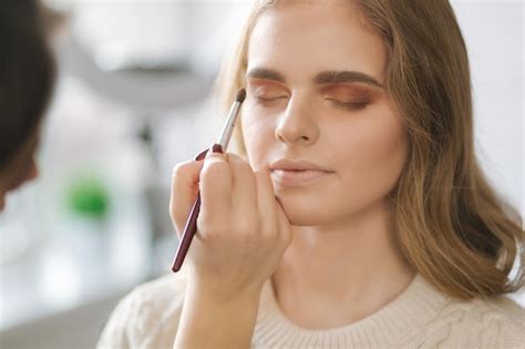 Premium Photo | Model have a makeup by makeup artist in beauty salon ...