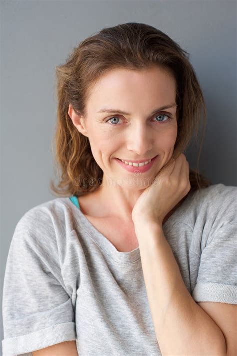Beautiful Mid Adult Woman Smiling Against Gray Background Stock Image ...