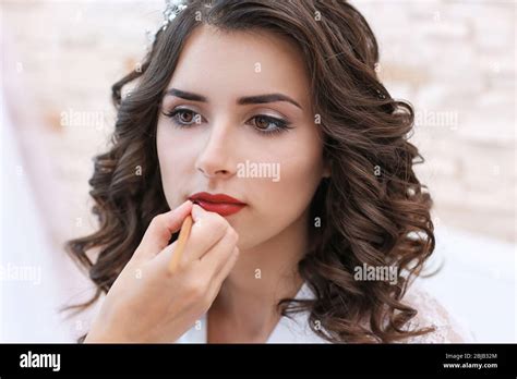 Makeup artist preparing bride before her wedding Stock Photo - Alamy
