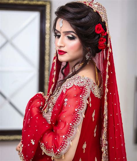 Download A Beautiful Bride In Red Bridal Wear | Wallpapers.com
