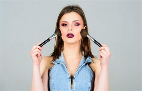 Premium Photo | Makeup dark lips Attractive woman applying makeup brush ...