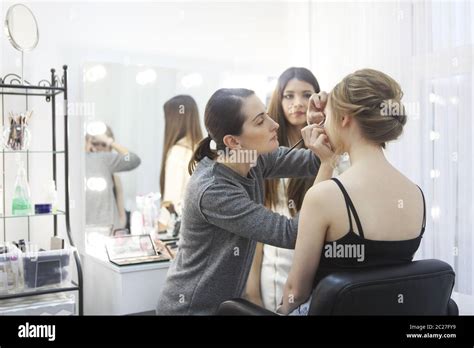 Makeup teacher with her student girl. Make up tutorial lesson at beauty ...