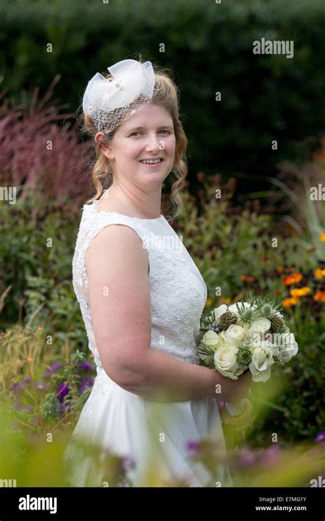 A bride smiling on her wedding day Stock Photo - Alamy