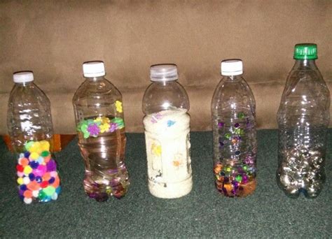 My sensory bottles - small pompoms, sequins and foam stickers in water ...