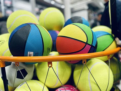 A pile of tennis balls sitting on top of a rack photo – Free United ...