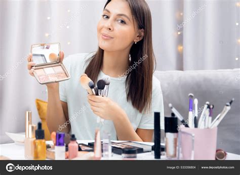 Woman beauty blogger shows tutorial on natural makeup and facial skin ...