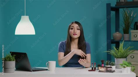 Content creator recording beauty vlog with cosmetics in studio, filming ...