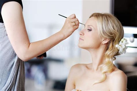 Young beautiful bride applying wedding make-up. By make-up artist , #Ad ...